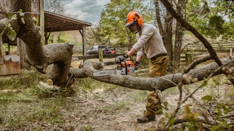 Man using a strom chainsaw.