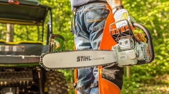 Man walking in woods with MS 291 STIHL Chainsaw 