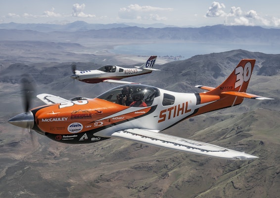 Two STIHL planes flying over mountains 