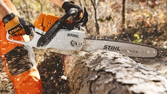 MS311 chainsaw cutting through a tree that is laying on the ground 