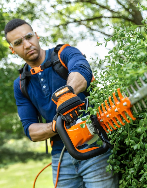 Man using HSA 94 on a hedge.
