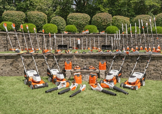 A group of STIHL battery products sitting on grass.