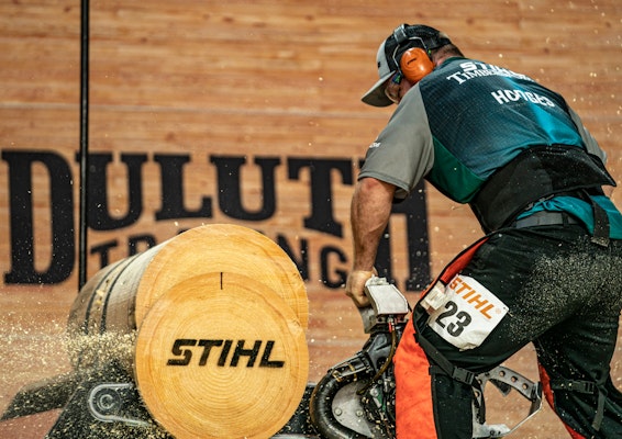 STIHL Timbersports contestant using a chainsaw to cut through wood 