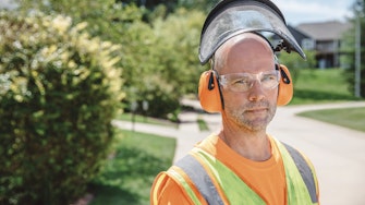 Male landscaper wearing protective equipment
