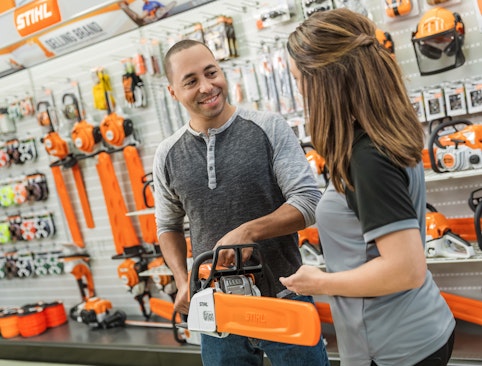 STIHL dealer helping customer pick out a chainsaw
