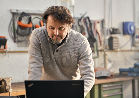 Man looking at computer in shop