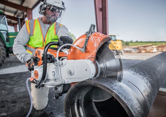 Construction worker using TS700 on large metal pipe