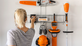 Tools mounted on white wall in garage