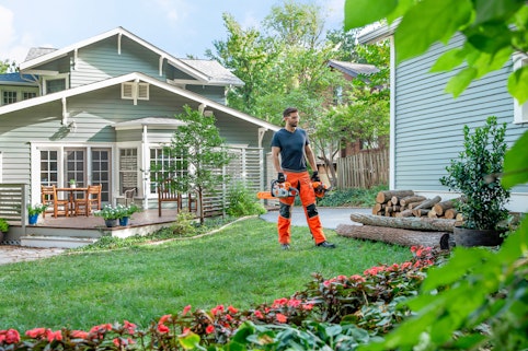 Man with chainsaw in yard