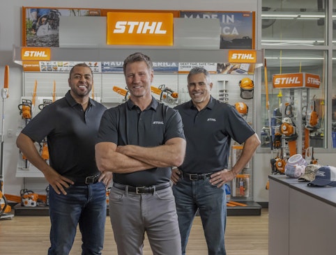 Three male STIHL dealers standing together in a store