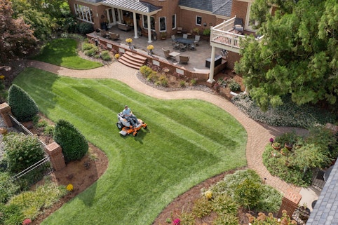 Homeowner mowing yard