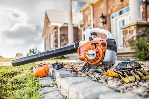 STIHL BG 56 C  blower sitting in rocks with personalized protection equipment.