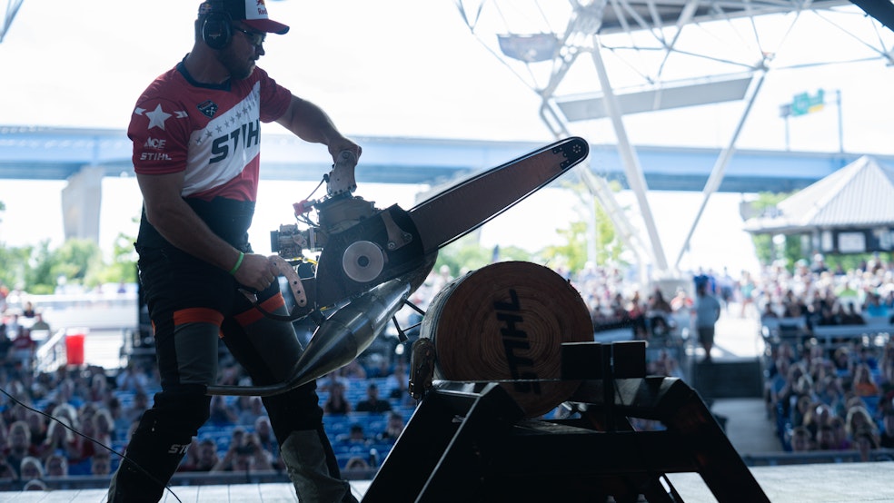 Man using STIHL chainsaw to compete in lumberjack competition