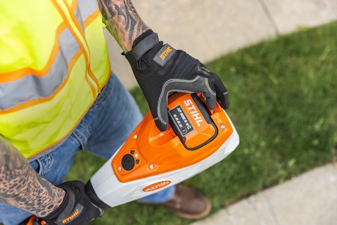 Battery being put into trimmer body