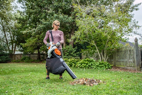 Woman using shredder vacuum