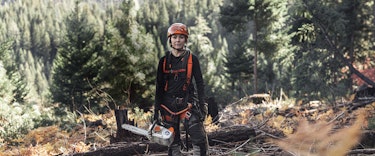Arborist Katelyn Johnson stands with STIHL Professional Chainsaw