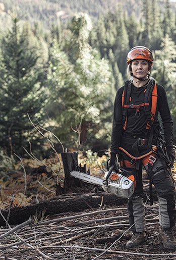 Arborist Katelyn Johnson stands with STIHL Professional Chainsaw