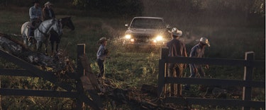 Family of ranchers working in the rain