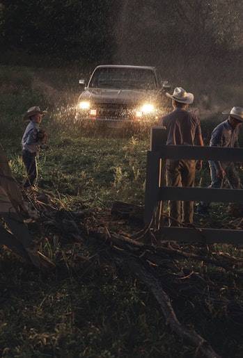 Family of ranchers working in the rain