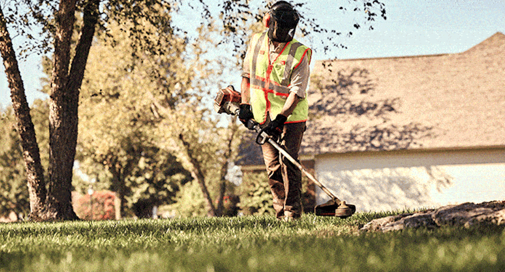 Professional Landscaper Trimming Grass with STIHL FSA 135 R