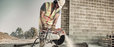 Professional construction worker cuts metal pipe with TS 420 STIHL Cutquick® Cut-Off Machine