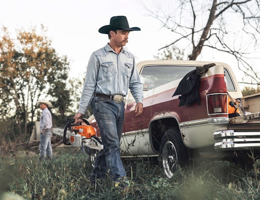 Man using STIHL chainsaw on ranch
