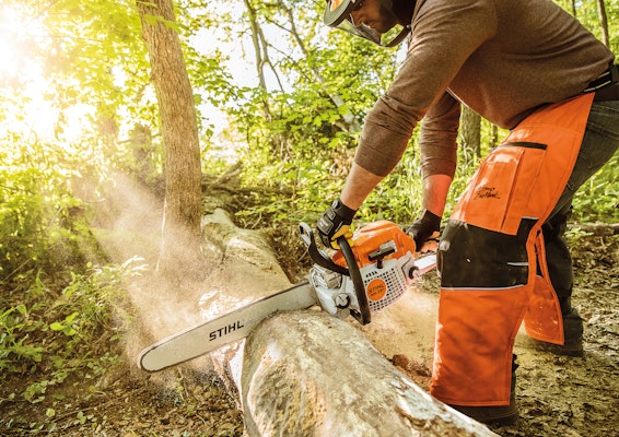 Man using STIHL MS 291 Chainsaw to cut wood
