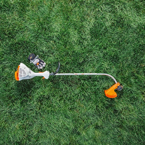 STIHL FS 40 C-E Trimmer and PPE from overhead in grass