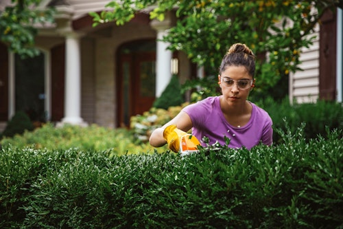 Woman using STIHL HSA 26 gardening tool